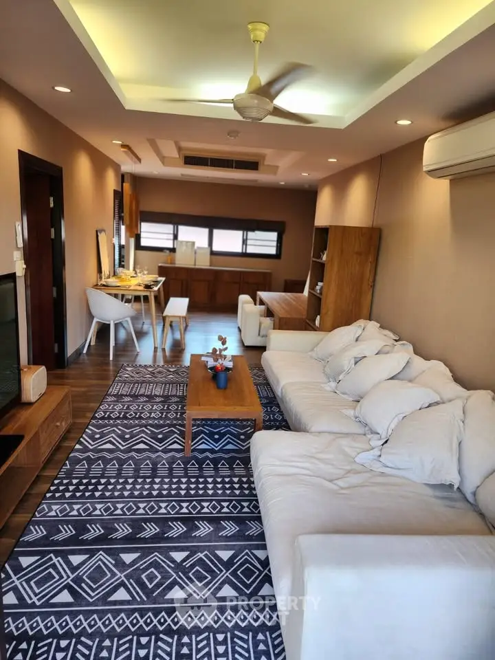 Spacious living room with modern decor and cozy seating area