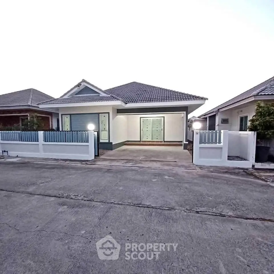 Charming single-story home with modern design and spacious driveway in a serene neighborhood.