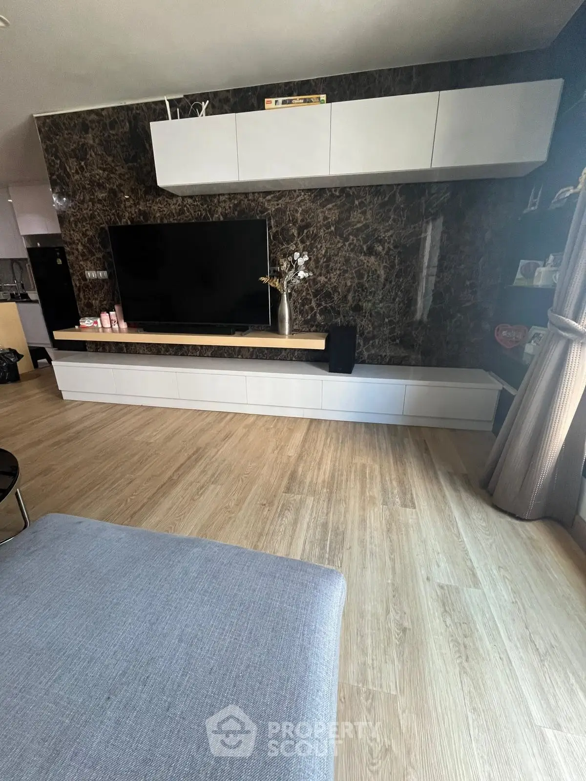 Modern living room with sleek TV unit and elegant wood flooring