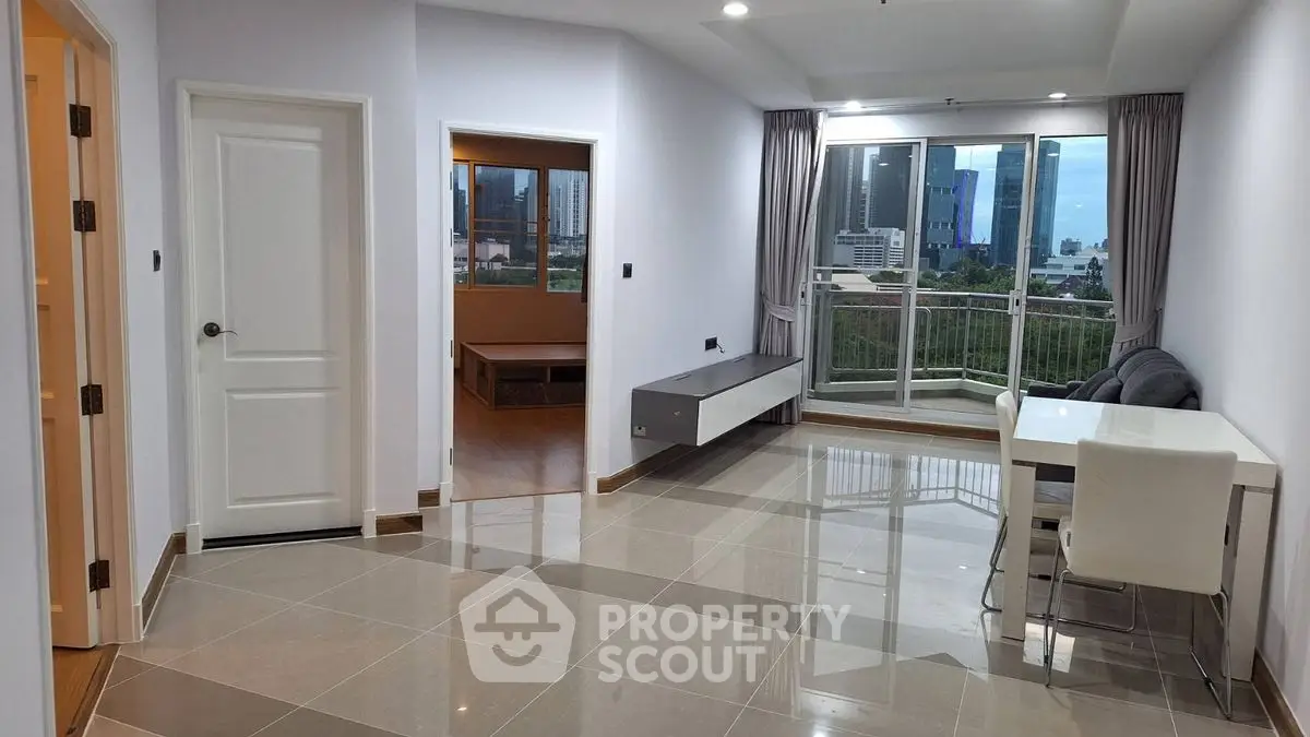 Modern open living room with city view and balcony access