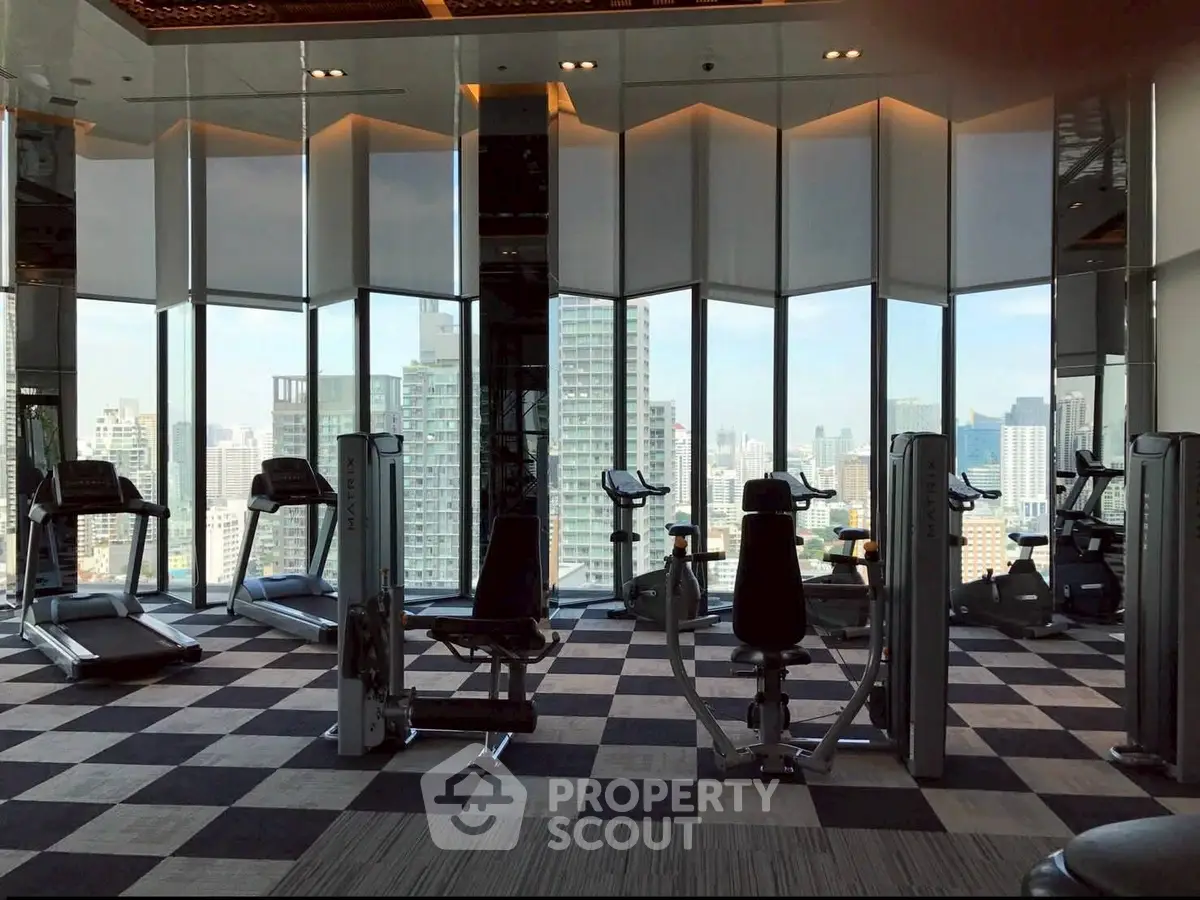Luxurious high-rise gym with panoramic city views and modern fitness equipment.