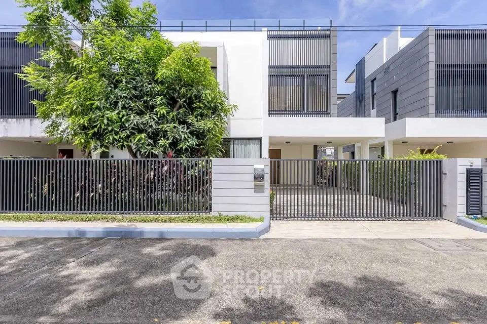Modern architectural home with sleek facade and lush greenery, perfect for contemporary living.