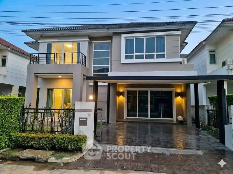 Modern two-story house with spacious driveway and elegant facade in suburban neighborhood.