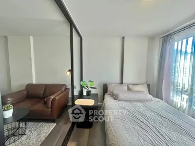 Modern studio apartment with cozy living area and natural light