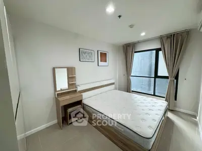 Modern bedroom with large window and minimalist furniture in a stylish apartment.