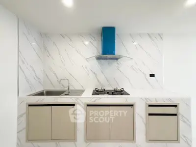 Modern kitchen with sleek marble backsplash and gas stove