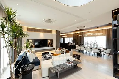 Luxurious open-plan living and dining area with modern decor and ample natural light.