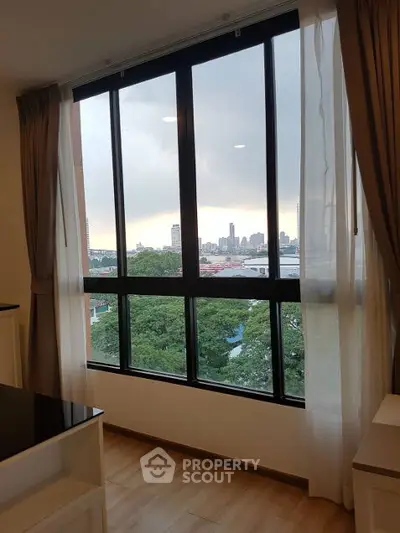 Spacious apartment with large windows offering stunning city views.