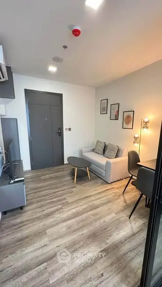 Modern living room with stylish decor and cozy seating in a contemporary apartment.