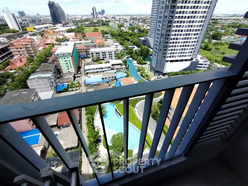 Stunning high-rise balcony view overlooking cityscape and pool, perfect for urban living.