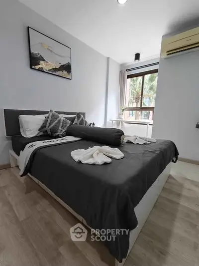Modern bedroom with stylish decor and large window view