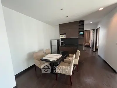 Modern dining area with sleek kitchen in open layout apartment