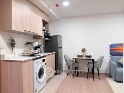 Modern kitchen with washing machine and dining area in stylish apartment