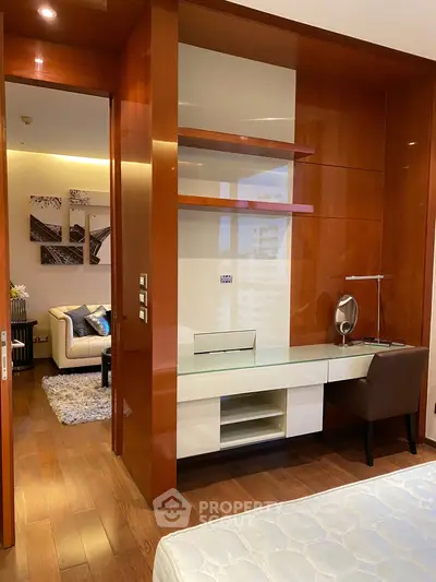 Luxurious bedroom with elegant wooden finishes and modern study area, perfect for urban living.