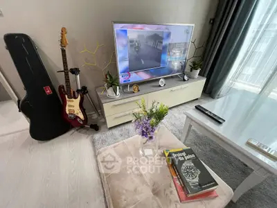 Modern living room with stylish decor, guitar, and TV setup, perfect for relaxation and entertainment.