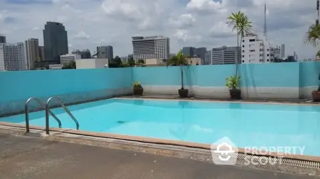 Stunning rooftop pool with city skyline views, perfect for relaxation and leisure.