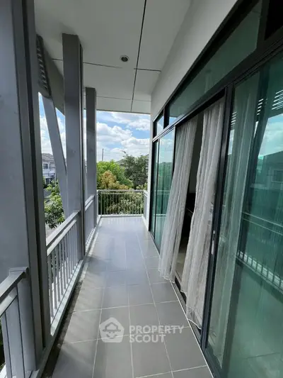 Spacious balcony with modern design and scenic view, perfect for relaxation.