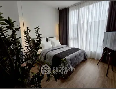 Modern bedroom with stylish decor and large window for natural light
