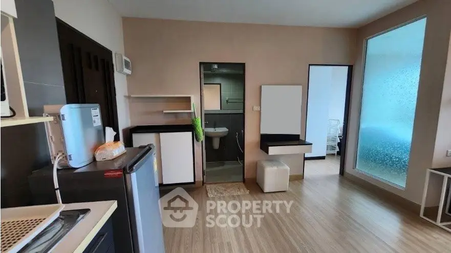 Modern studio apartment with open layout and sleek wooden flooring