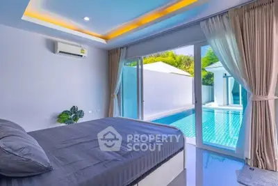 Luxurious bedroom with pool view and modern design in a serene setting.