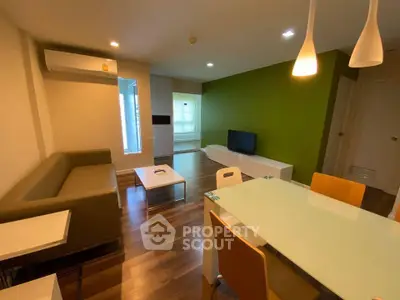 Modern living room with stylish furniture and vibrant green accent wall