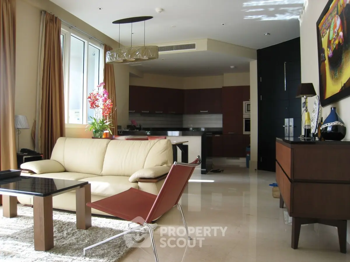 Luxurious modern living room with elegant furniture and open kitchen layout, perfect for stylish urban living.