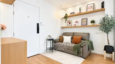 Charming modern living room with cozy sofa, stylish decor, and wooden flooring, perfect for relaxation.