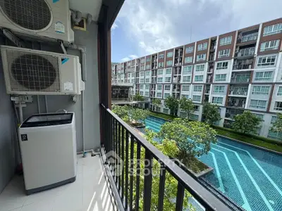 Modern apartment balcony with pool view and washing machine, perfect for urban living.
