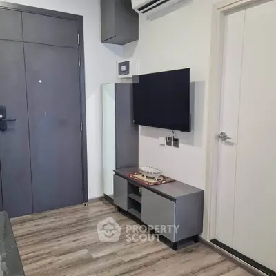 Modern living room with sleek TV setup and stylish flooring
