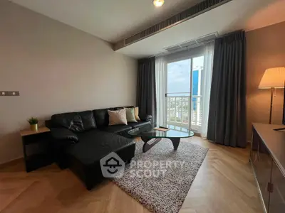 Modern living room with city view, stylish furniture, and natural light.