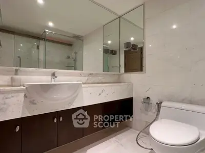 Modern bathroom with sleek fixtures and marble accents