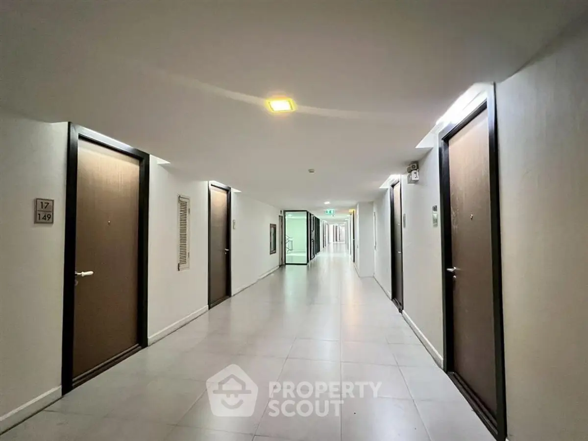 Modern apartment corridor with sleek design and multiple doors, ideal for urban living.