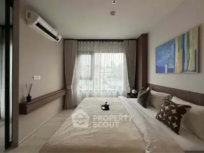 Modern bedroom with city view, featuring stylish decor and natural light.