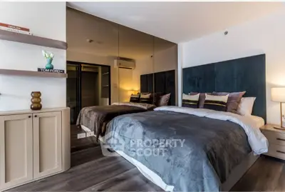 Luxurious modern bedroom with mirrored wall and elegant decor