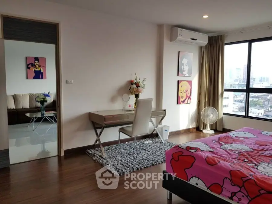 Stylish bedroom with city view, modern decor, and vibrant artwork.
