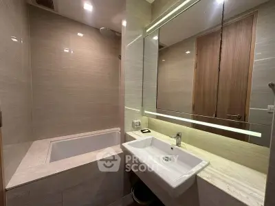 Modern bathroom with sleek sink and bathtub in luxury apartment