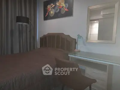 Cozy bedroom with modern decor, featuring a comfortable bed, stylish desk, and elegant lighting.