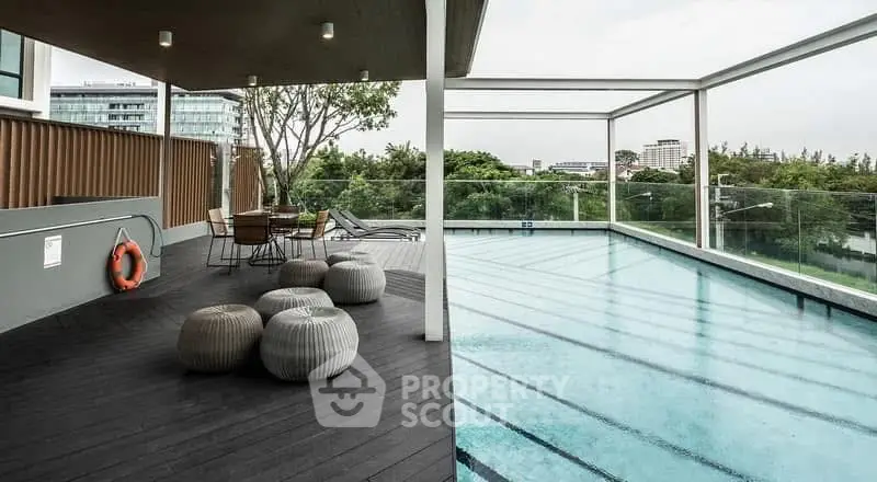 Luxurious rooftop pool with modern seating and stunning city views, perfect for relaxation and entertainment.