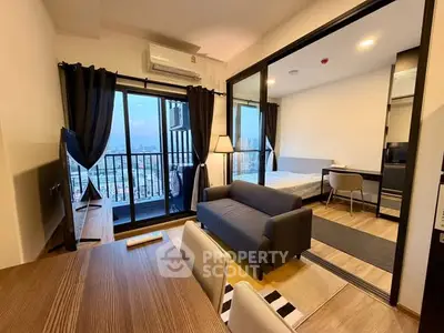 Modern apartment with open layout, featuring a cozy living room and bedroom with city view balcony.