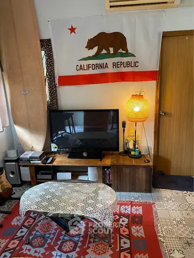 Cozy living room with California Republic flag, surfboard, and eclectic decor.
