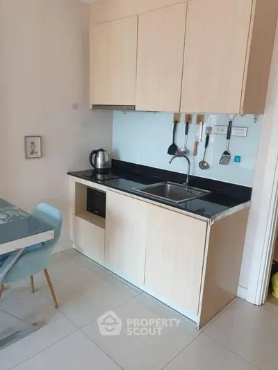 Modern compact kitchen with sleek cabinetry and dining area