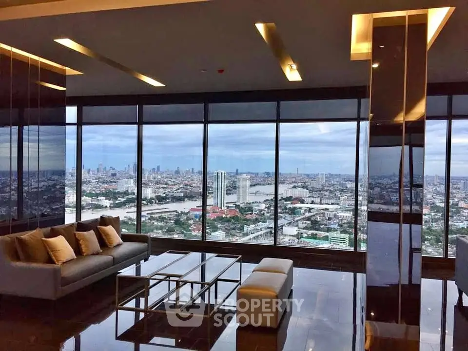 Luxurious high-rise living room with panoramic city view and modern furnishings.