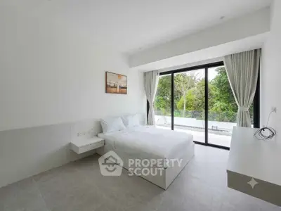 Spacious bedroom with large windows and serene garden view