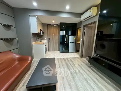 Modern living room with sleek design and open kitchen layout