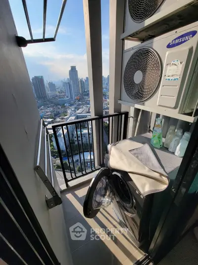 Compact balcony with washing machine and city view, perfect for urban living.