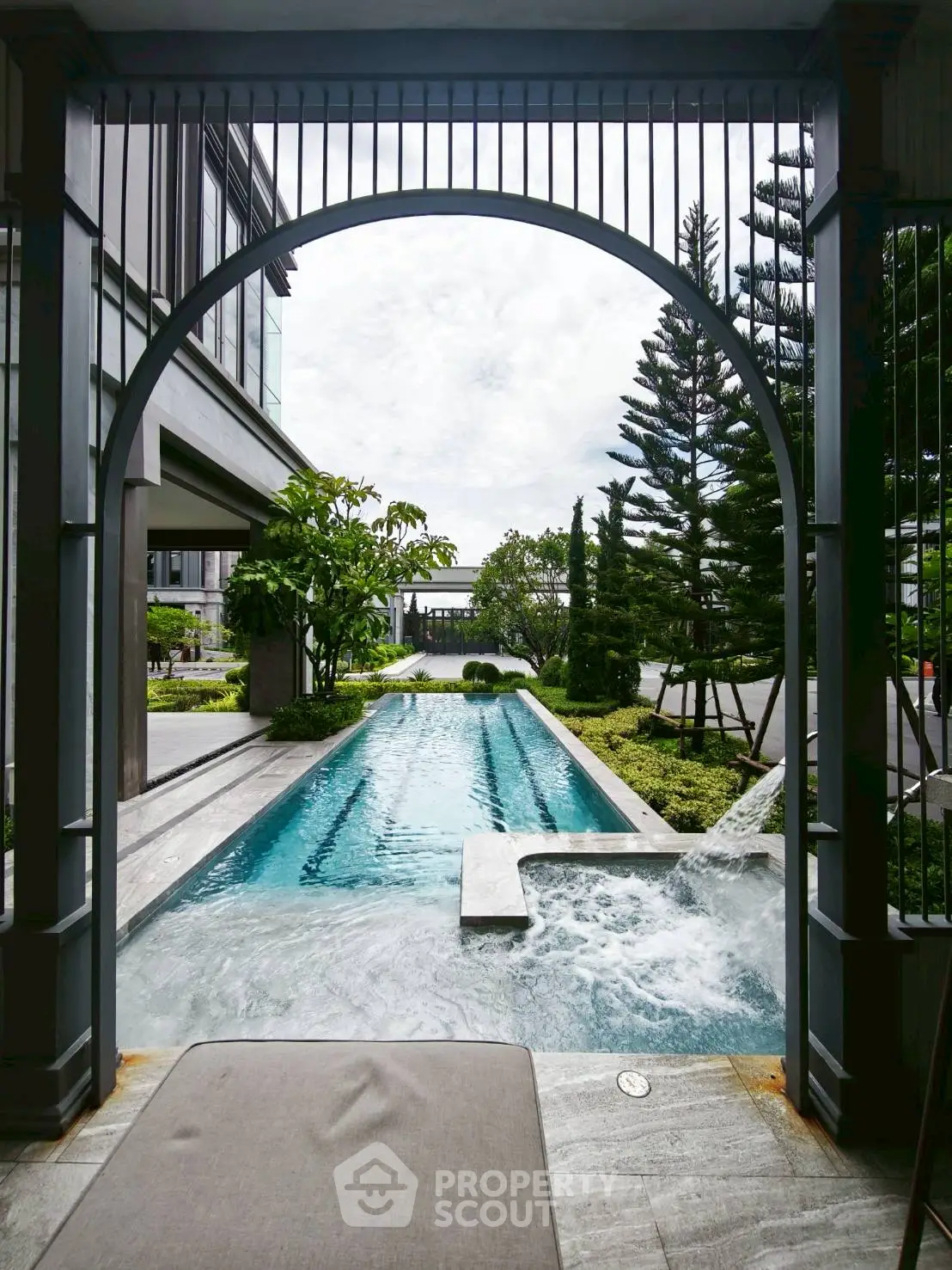 Luxurious outdoor pool with elegant landscaping and modern architecture.