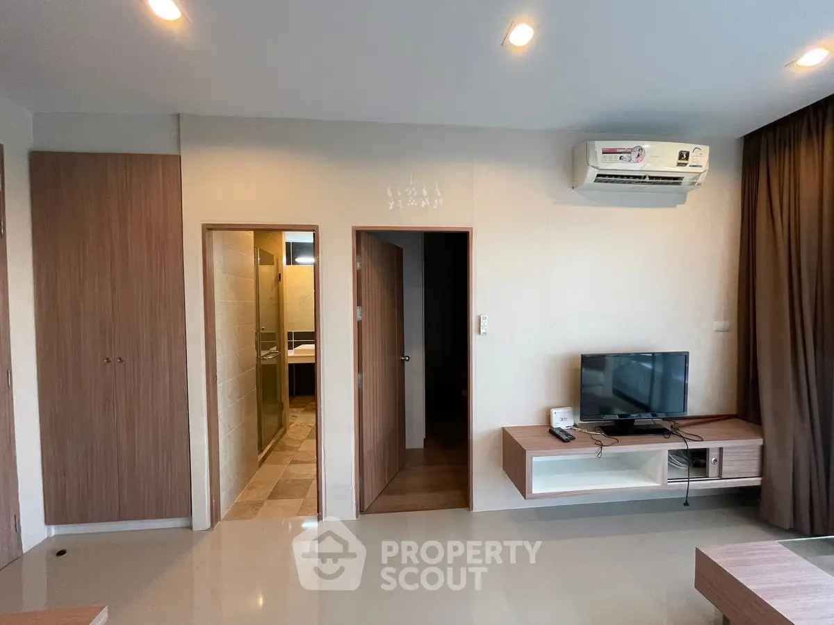Modern living room with sleek furniture and air conditioning unit