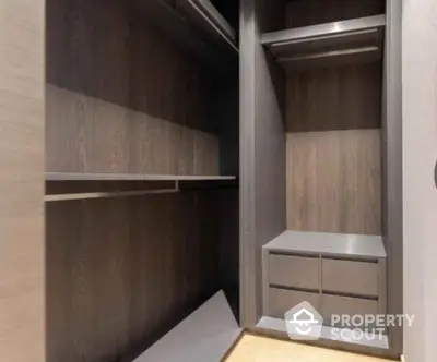 Spacious modern walk-in closet with sleek wooden finish and ample storage space.