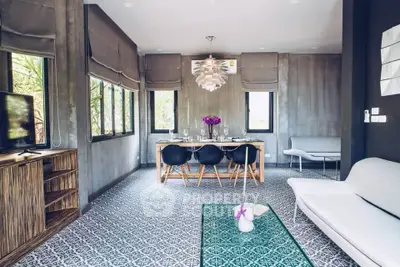 Modern living room with stylish decor and large windows offering natural light.