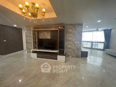 Spacious modern living room with elegant chandelier and large windows